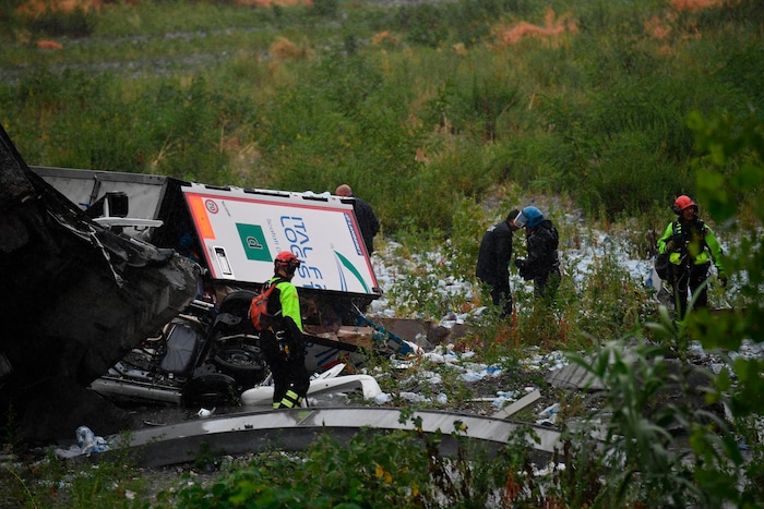 Rescues work among the debris of the collapsed Morandi highway bridge in Genoa, Tuesday, Aug. 14, 2018. Italian authorities say that about 10 vehicles were involved when the raised highway collapsed during a sudden and violent storm in the northern port city of Genoa, while private broadcaster Sky TG24 said the collapsed section was about 200-meter long (650 feet). (Luca Zennaro/ANSA via AP)