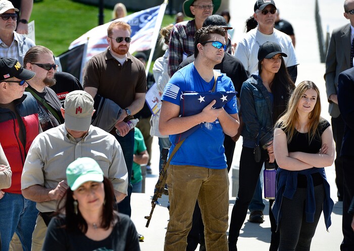 (Scott Sommerdorf | The Salt Lake Tribune)
A man clutching a flag and carrying a gun listened to speakers as a group calling themselves Citizens and Students For Liberty (SFL) gathered at the Utah State Capitol on Saturday to show their support for the Second Amendment, Saturday, April 14, 2018.
