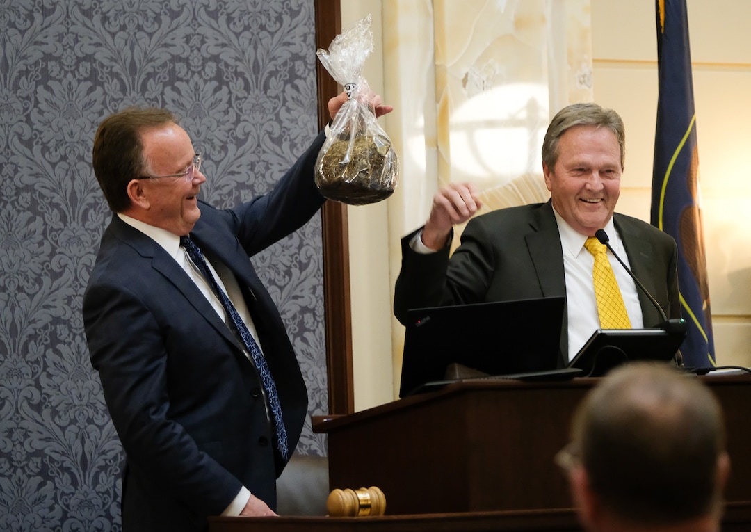 (Francisco Kjolseth  |  The Salt Lake Tribune)  Senate President Stuart Adams ,R-Layton, is presented with a bag of elephant dung "worked on all day by our friends at Hogle Zoo" exclaimed Senator Jerry Stevenson, R-Layton, during the final minutes of the Legislative session at the Utah Capitol on Thursday, March 14, 2019.
