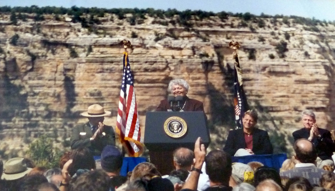 (photo courtesy Ron Fox) Norma Matheson speaks at an event in Arizona where President Bill Clinton announced the designation of the Grand Staircase-Escalante National Monument. Behind her are President Clinton and Vice President Al Gore.