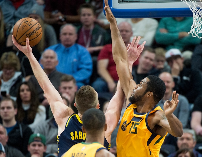 (Rick Egan  |  The Salt Lake Tribune)   Indiana Pacers center Domantas Sabonis (11) shoots as Utah Jazz forward Derrick Favors (15) defends, in NBA action Utah Jazz vs Indiana Pacers, in Salt Lake City, Monday, January 15, 2018.


