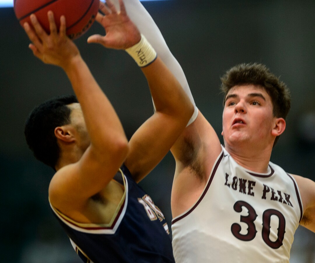 (Steve Griffin  |  The Salt Lake Tribune) Lone Peak's Jackson Brinkerhoff stretches to block the shot of Herriman's Nathaniel Cundiff during 6A basketball playoff game at the Utah Valley UniversityÕs UCCU Center in Provo Tuesday Feb. 27, 2018.
