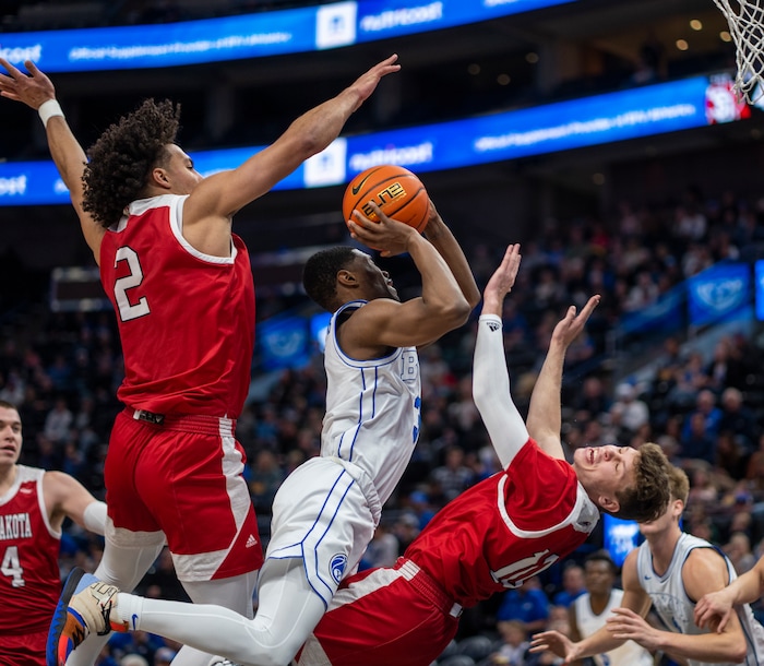 (Rick Egan | The Salt Lake Tribune)  Brigham Young Cougars guard Rudi Williams (3) is called for an offensive foul, as he collides with South Dakota Coyotes guard A.J. Plitzuweit (10) and South Dakota Coyotes guard A.J. Plitzuweit (10), in basketball action between the Brigham Young Cougars and the South Dakota Coyotes, at Vivint Arena, in Salt Lake City, on Saturday, Dec. 3, 2022.
