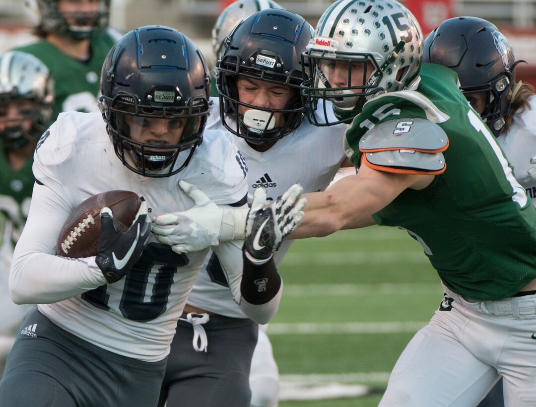 (Rick Egan  |  The Salt Lake Tribune)    Corner Canyon quarterback Austin Bell runs the ball for the Chargers,  As Olympus Noah Bennee defends, in 5A football semifinal action between Olympus and Corner Canyon at Rice-Eccles Stadium, Thursday, Nov. 8, 2018.