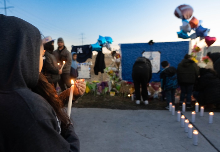 (Francisco Kjolseth | The Salt Lake Tribune) More that a hundred people gather at the candlelight vigil of Hunter High football players Paul Tahi , 15, Tivani Lopati, 14, and Ephraim Asiata, 15, on Friday, Jan 14, 2022, in West Valley City, near Hunter High School along 1400 South at Mountain View Corridor. Paul Tahi and Tivani Lopati were killed in a shooting, while Ephraim Asiata remains in critical condition.