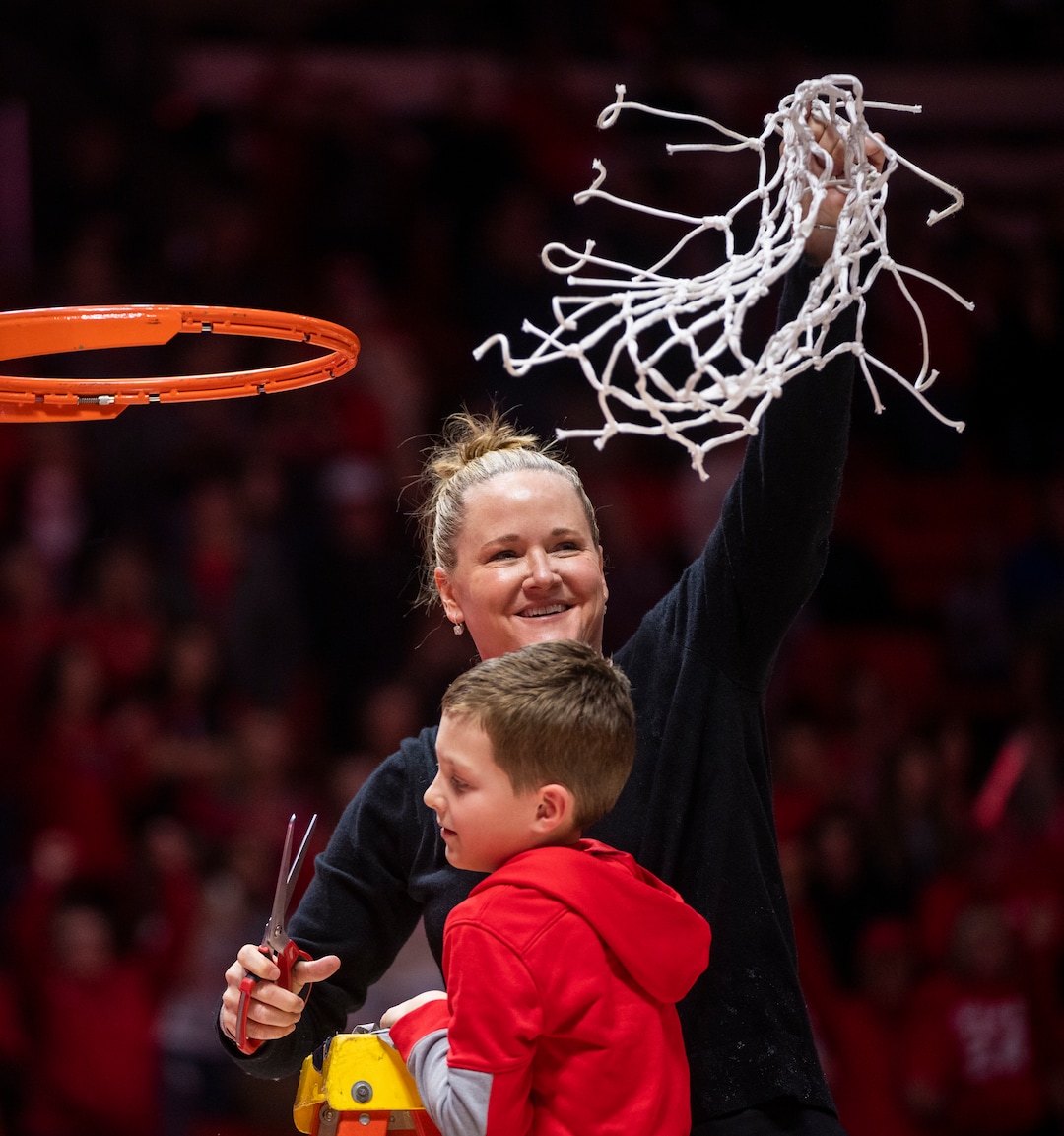 (Rick Egan | The Salt Lake Tribune) Utah Head Coach Lynne Robertscuts down the net with her son Miles, as they celebrate the Utes 84-78 win over the Stanford Cardinals, in PAC-12 action, at the Jon M. Huntsman Center, on Saturday, Feb. 25, 2023.
