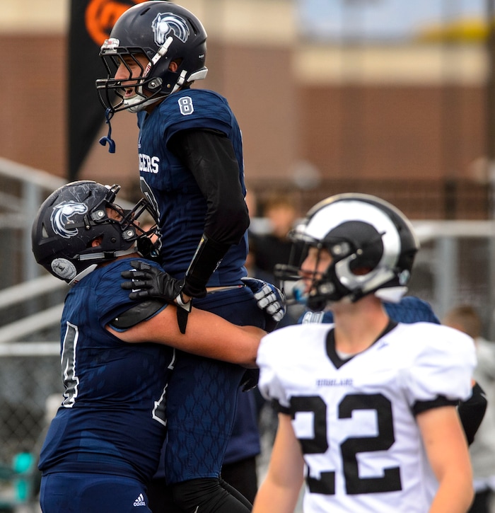 (Steve Griffin  |  The Salt Lake Tribune)  Corner Canyon wide receiver Colton Lawson is hoisted into the air by teammate Cole Hagen after he scored a touchdown on a long pass during the Class 5A state quarterfinal football game against Highland at Corner Canyon in Draper Friday November 3, 2017.