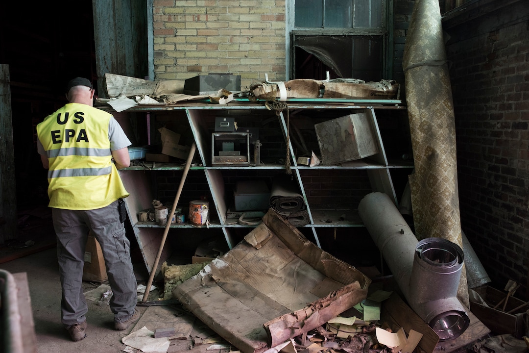 (Briana Scroggins  |  The Utah Investigative Journalism Project) EPA On-scene Coordinator Paul Peronard takes a look at a container on a tilted shelf in the Swift building in Ogden on Thursday, May 16, 2019. The EPA started site clean up on April 1 and plan to finish by August 2019.