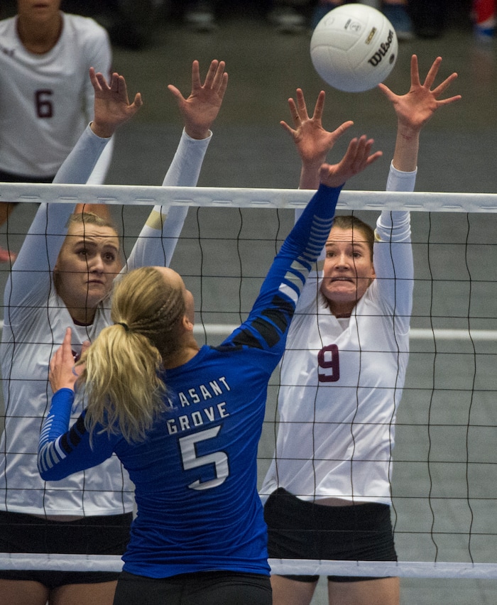 (Rick Egan  |  The Salt Lake Tribune)   Pleasant Grove Vikings Heather Gneiting (5) hits the ball, as  Lone Peak Knights  Madelyn Robinson (9) defends,  in the 6A volleyball championship action, Pleasant Grove vs. Lone Peak, at Utah Valley University, Saturday, November 4, 2017.