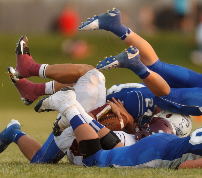 (Trent Nelson  |  The Salt Lake Tribune)  The Fremont defense tackles Jordan quarterback Austin Kafentzis as Fremont hosts Jordan High School football in Ogden, Utah Friday, August 17, 2012.