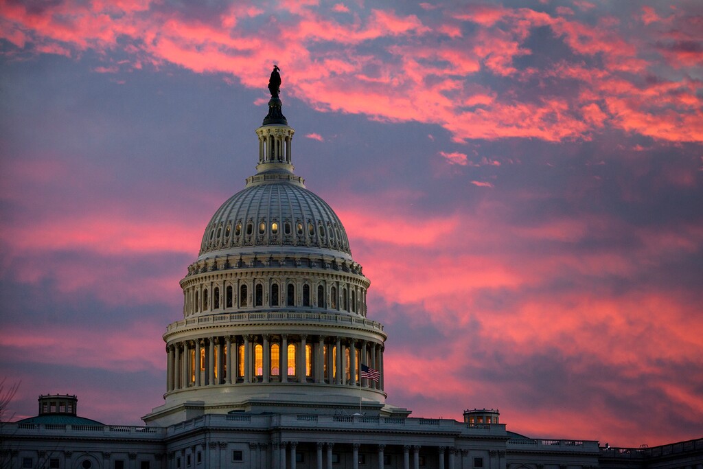 FILE - In this Thursday, Nov. 30, 2017, file photo, the sky over The Capitol is lit up at dawn as Senate Republicans work to pass their sweeping tax bill, in Washington. Congress' last major tax overhaul, three decades ago, was everything this year’s version isn’t. The Tax Reform Act of 1986 won bipartisan support. Its benefits flowed more to low- and middle-income taxpayers than to wealthy individuals and corporations. And it added nothing to the federal deficit. None of that can be said for tax-cut package the Senate passed after the House approved a similar version. (AP Photo/J. Scott Applewhite, File)