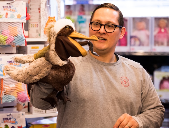 (Rick Egan  |  The Salt Lake Tribune)       Casey Sartain demonstrates some of the unique toys they sell at The Tutoring Toy on Foothill Drive, such as Folkmanis Puppets.  Thursday, March 22, 2018.