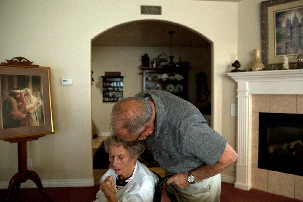 Bill Trowbridge kisses his wife, Kay in their home in Orem, Utah, on Friday, Oct. 6, 2017.  Kay has been diagnosed with Alzheimer's for several years. "She knows who I am about 40 percent of the time now," says Bill.  Alzheimer’s is often referred to as the silver tsunami, affecting around 30,000 people over the age of 65 in the state of Utah with that number increasing at a rapid rate, according to the Alzheimer’s Association.   (Sammy Jo Hester/The Daily Herald via AP)