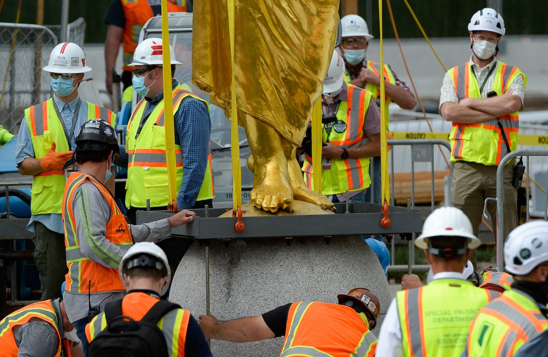 (Francisco Kjolseth  |  The Salt Lake Tribune) The Angel Moroni statue is pulled from atop the Salt Lake Temple of The Church of Jesus Christ of Latter-day Saints on Monday, May 18, 2020. The temple closed in December for seismic upgrades and sustained minor damager during the March 18, 2020, magnitude 5.7 earthquake when the trumpet held by the angel fell off and several smaller spire stones were displaced.