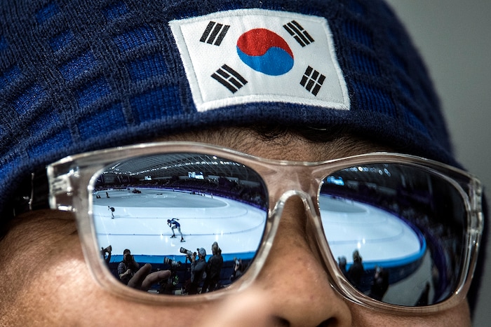 (Chris Detrick  |  The Salt Lake Tribune)  A Japanese fan watches as Nao Kodaira and Czech Republic's Karolina Erbanova race in the Ladies' 500m at the Gangneung Oval during the Pyeongchang 2018 Winter Olympics Sunday, Feb. 18, 2018. Kodaira won the event with a time of 36.94. Erbanova finished in 3rd place with a time of 37.34.