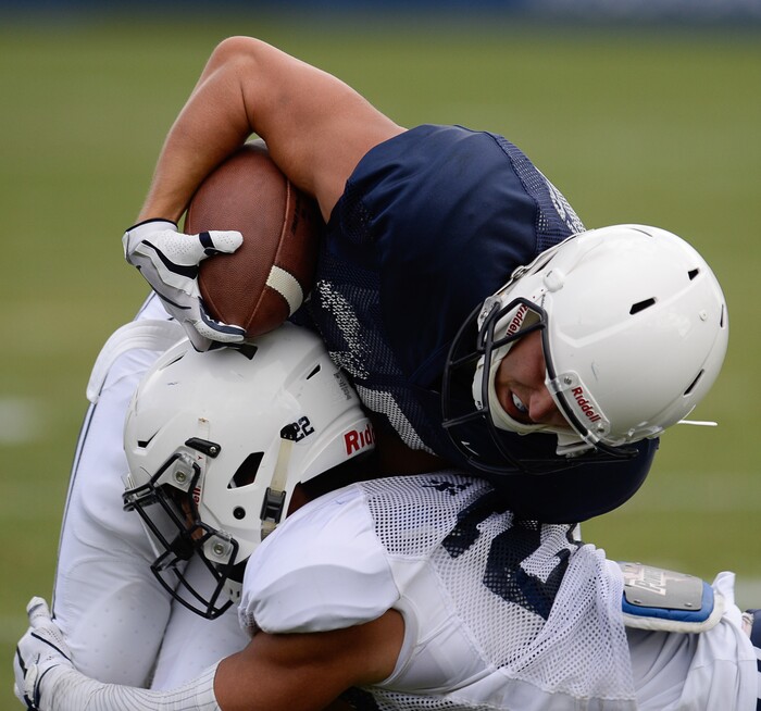 (Francisco Kjolseth  |  The Salt Lake Tribune)  Taggart Krueger gets tackled by Hiva Lee as BYU holds a scrimmage at LaVell Edwards Stadium in Provo on Thursday, Aug. 10, 2017.