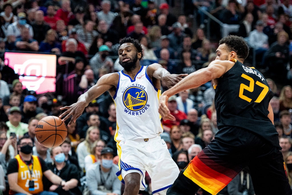 Golden State Warriors forward Andrew Wiggins (22) loses control of the ball while guarded by Utah Jazz center Rudy Gobert (27) during the first half of an NBA basketball game Saturday, Jan. 1, 2022, in Salt Lake City. (AP Photo/Isaac Hale)