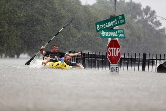 (Mark Mulligan| Houston Chronicle via AP) Two kayakers try to beat the current pushing them down an overflowing Brays Bayou from Tropical Storm Harvey in Houston, Texas, Sunday, Aug. 27, 2017.