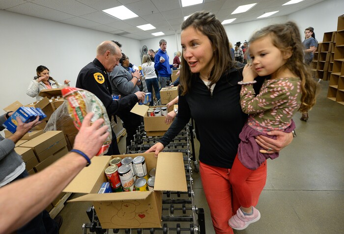 (Francisco Kjolseth  |  The Salt Lake Tribune) Salt Lake City Mayor Erin Mendenhall works the line with daughter Mila LaMalfa, 4, in tow as they volunteer at the Utah Food Bank for the Martin Luther King Jr. Day of Service on Monday, Jan. 20, 2020.