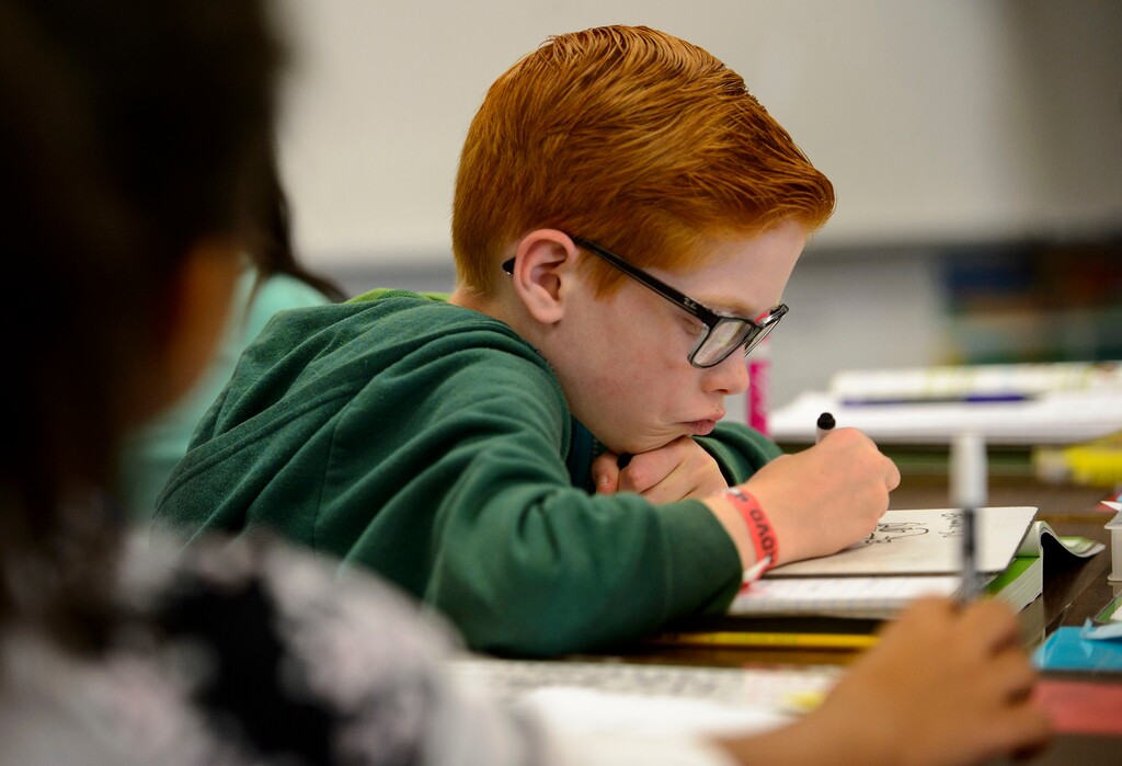 (Steve Griffin  |  The Salt Lake Tribune) Fifth-grader Ryan Graves works math equations at East Midvale Elementary  in Midvale, Utah Monday September 25, 2017. The school improved by two letter grades in the latest release of school grading.