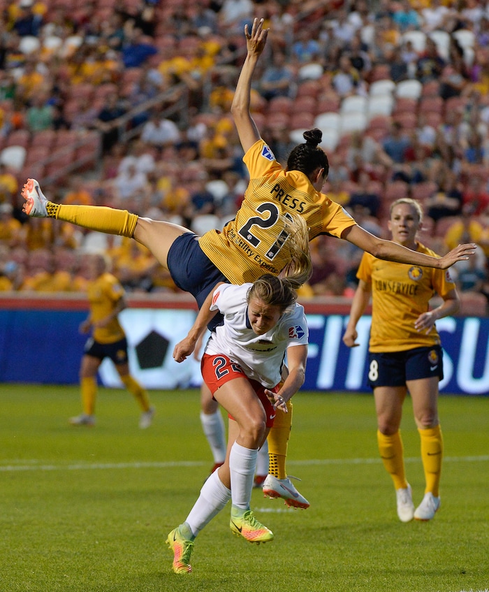 (Francisco Kjolseth  |  The Salt Lake Tribune)  Utah Royals FC hosts Washington Spirit, NWSL soccer at Rio Tinto Stadium in Sandy, Wed. Aug. 8, 2018. Utah Royals FC forward Christen Press (21) ends up in a precarious place over Washington Spirit forward Mallory Eubanks (22) following a header in the first half of the game. 