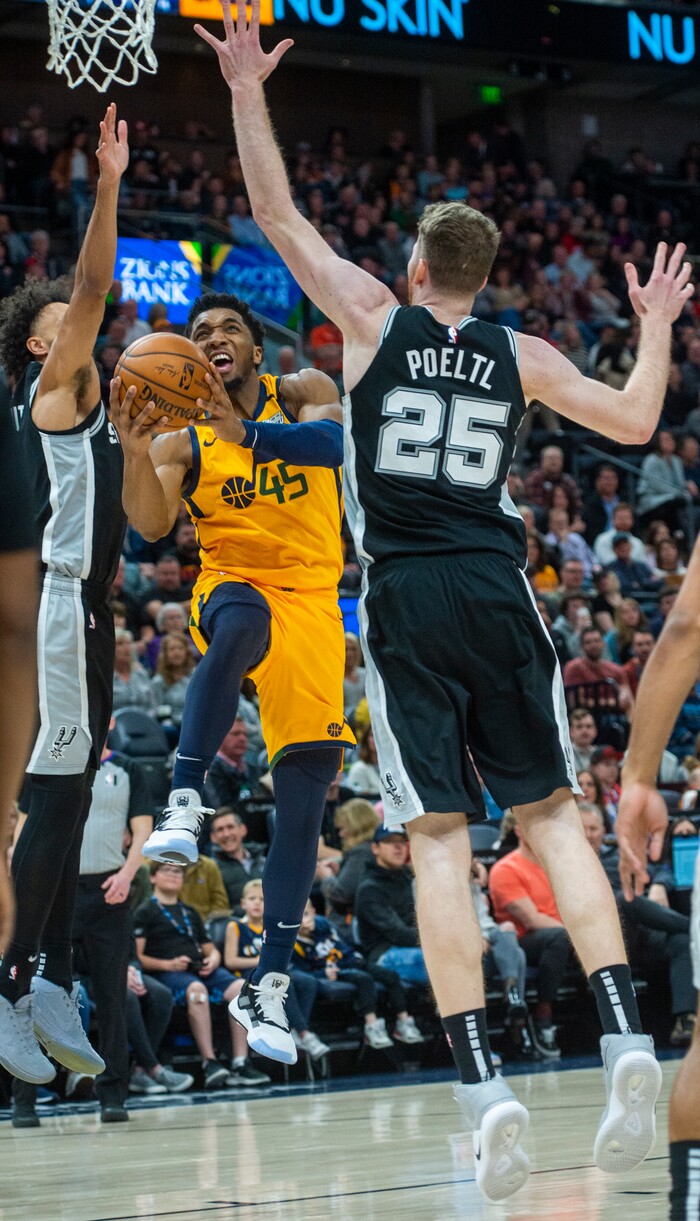(Rick Egan  |  The Salt Lake Tribune)    
Utah Jazz guard Donovan Mitchell (45) takes the ball to the hoop, as San Antonio Spurs center Jakob Poeltl (25) defends, in NBA action between the Utah Jazz and the San Antonio Spurs, in Salt Lake City, Friday, Feb. 21, 2020.