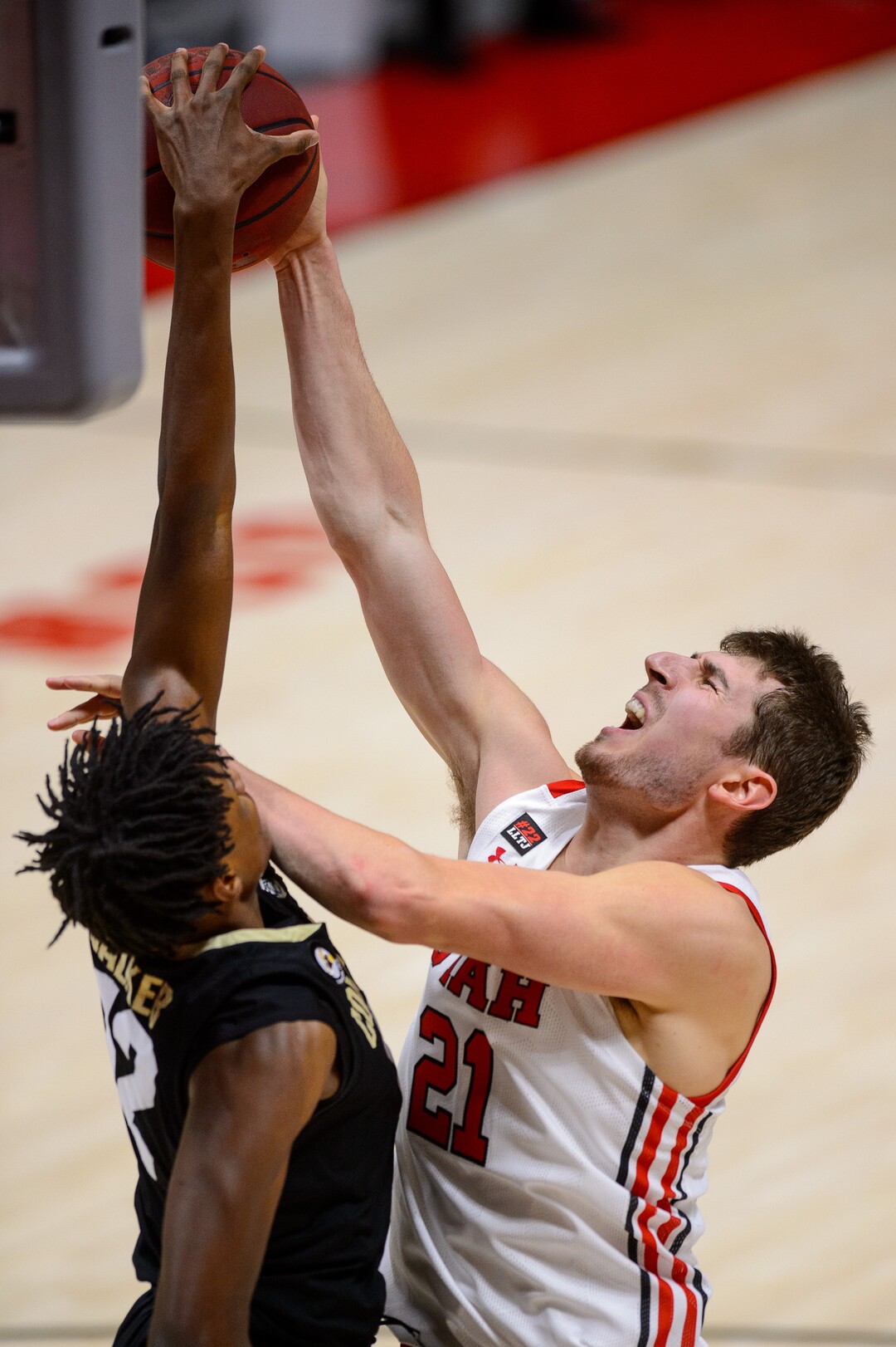 (Trent Nelson  |  The Salt Lake Tribune) Utah Utes forward Riley Battin (21) defended by Colorado Buffaloes forward Jabari Walker (12) as Utah hosts Colorado, NCAA basketball in Salt Lake City on Monday, Jan. 11, 2021.