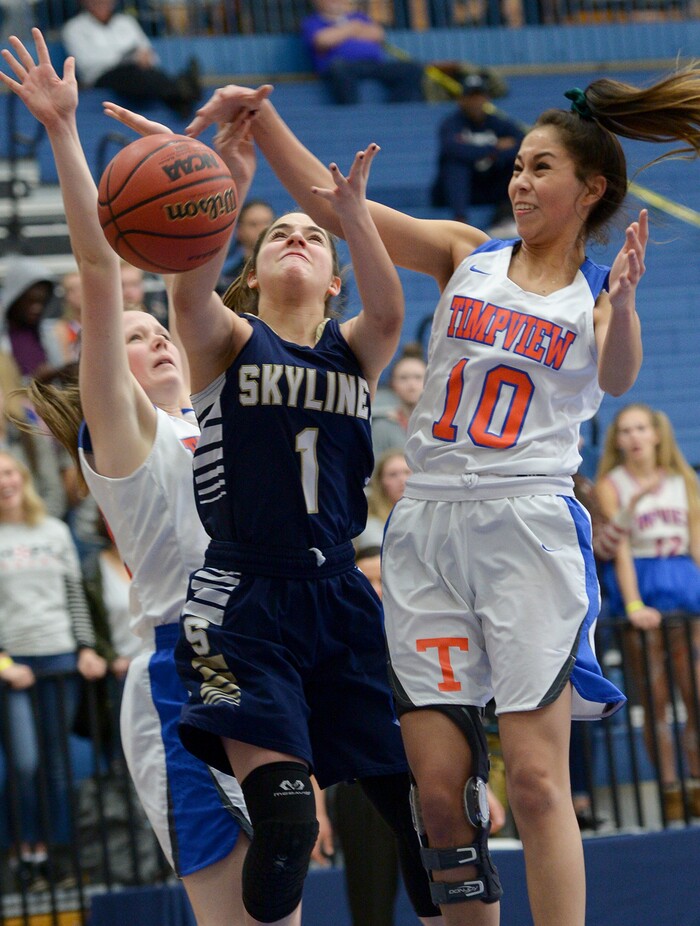 (Leah Hogsten  |  The Salt Lake Tribune) Timpview's Jasmine Espinoza (10) swats at Skyline's Amit Lustgarten (01).  Timpview faces Skyline in their semifinal game of the 5A High School Girls' Basketball Tournament at SLCC in Taylorsville, Friday, Feb. 23, 2018. 