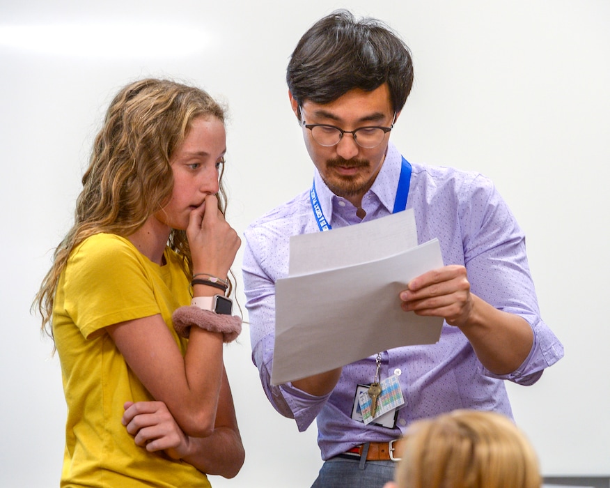 (Leah Hogsten | The Salt Lake Tribune) Eighth grade math instuctor Pinyi Yao helps student Allie Jones find the right classroom on the first day of school. Pinyi Yao, 27, a Chinese National teaching 8th and 9th grade math welcomes his students on their first day of the school year at Oquirrh Hills Middle School, August 20, 2019 in Riverton.