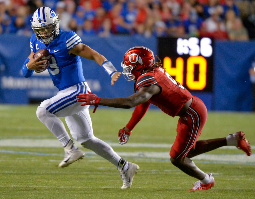 (Chris Samuels | The Salt Lake Tribune) Brigham Young Cougars quarterback Jaren Hall (3) tries to evade Utah Utes safety Vonte Davis (9) during a football game Saturday, Sept. 11, 2021 in Provo.