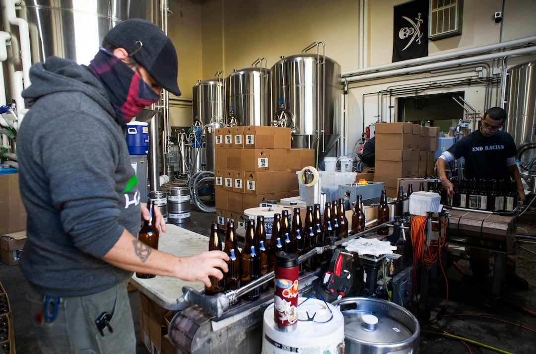 (Rick Egan  |  The Salt Lake Tribune)    Aaron Buckner  and Jordan Vigil bottle beer at Epic Brewing Co. in Salt Lake City, Thursday, Oct. 29, 2020.