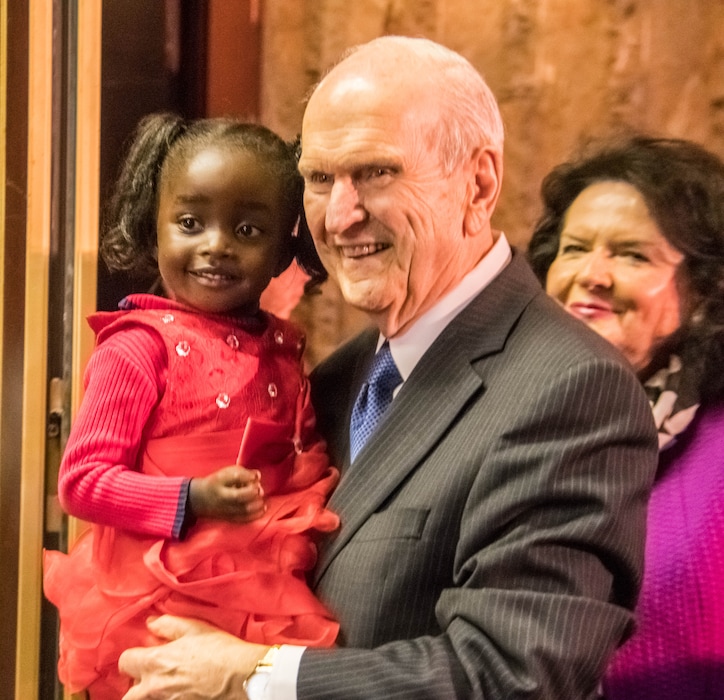 (Photo courtesy LDS Church) LDS President Russell M. Nelson holds a young girl from Zimbabwe's Mormon community during a stop in the southern Africa nation Tuesday. Nelson's wife, Wendy, also is pictured.