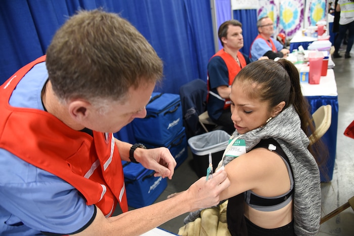 (Francisco Kjolseth  |  The Salt Lake Tribune)  Crystal Yllnas gets a flu shot from public health nurse Pete Stewart   during Salt Lake CityÕs second annual Project Homeless Connect at the Salt Palace Convention Center on Friday, Oct. 12, 2018. The event brought together community volunteers to provide services for individuals and families in need or experiencing homelessness. More than 800 community volunteers and 90 service providers connect those in need with more than 200 services.