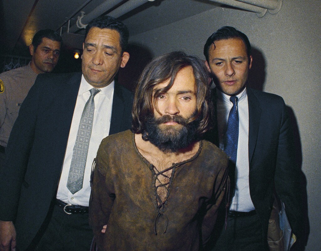 (AP Photo, File) In this 1969 file photo, Charles Manson is escorted to his arraignment on conspiracy-murder charges in connection with the Sharon Tate murder case. Authorities say Manson, cult leader and mastermind behind 1969 deaths of actress Sharon Tate and several others, died on Sunday, Nov. 19, 2017. He was 83.