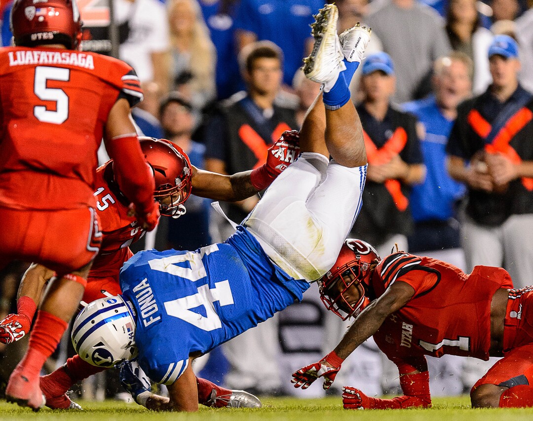 (Trent Nelson | The Salt Lake Tribune)  Brigham Young Cougars running back Kavika Fonua (44) leaps over Utah Utes defensive back Boobie Hobbs (1)as BYU hosts Utah, NCAA football in Provo, Saturday September 9, 2017.