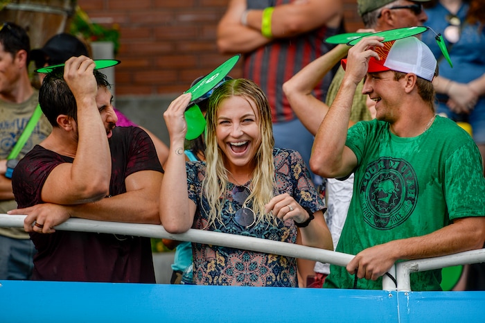 Leah Hogsten | The Salt Lake Tribune Fans lining Park City's Main Street braved the downpour minutes prior to cyclists crossing the finish at the Tour of Utah's Stage 6, Sunday, August 12, 2018.