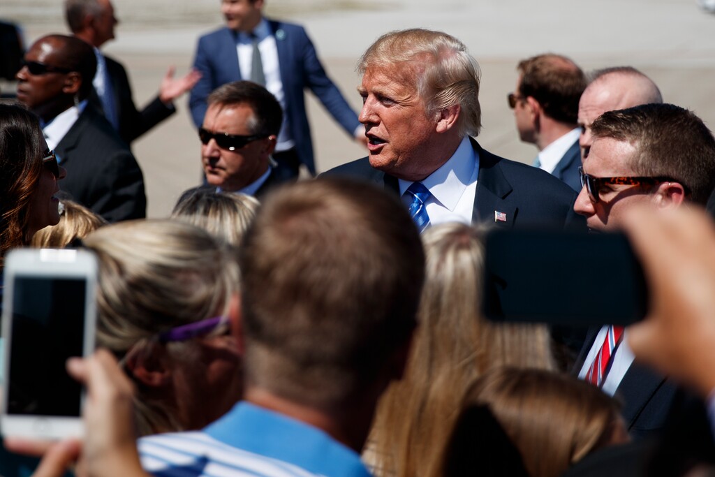 (Evan Vucci | The Associated Press) President Donald Trump greets supporters after arriving at the Kansas City International Airport to attend the national convention of the Veterans of Foreign Wars, Tuesday, July 24, 2018, in Kansas City, Mo.