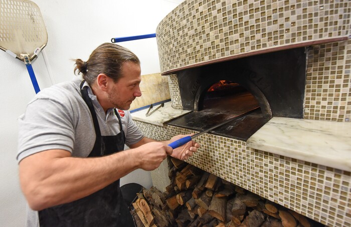 (Francisco Kjolseth | The Salt Lake Tribune) Ernesto Lo Russo, chef and owner of Terra Mia Italian restaurant in Draper, a sister restaurant to Terra Mia in Orem, rotates a wood fired pizza to reach perfection for customers during a recent lunch hour.