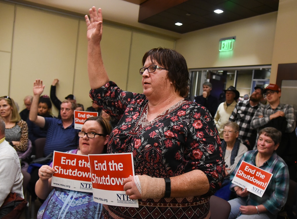 (Francisco Kjolseth | The Salt Lake Tribune) Shelly Carver a federal worker with the IRS in Ogden tries to ask a question as U.S. Senator Mitt Romney visits some of the overflow rooms after holding a town hall meeting at the Davis County administration building, Tuesday, January 22, 2019, to hear from local residents.