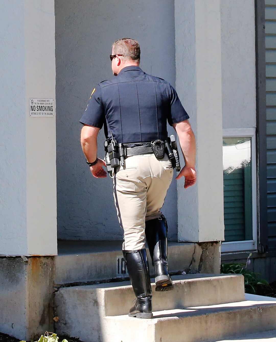 A police officer walks into a building where a man was taken into custody in connection with missing University of Utah student MacKenzie Lueck, Friday, June 28, 2019, in Salt Lake City. Authorities are filing murder and kidnapping charges in the death of a Utah college student who disappeared 11 days ago. Salt Lake City police chief Mike Brown said 31-year-old Ayoola A. Ajayi will be charged with aggravated murder, kidnaping and desecration of a body in the death of 23-year-old Mackenzie Lueck. (AP Photo/Rick Bowmer)