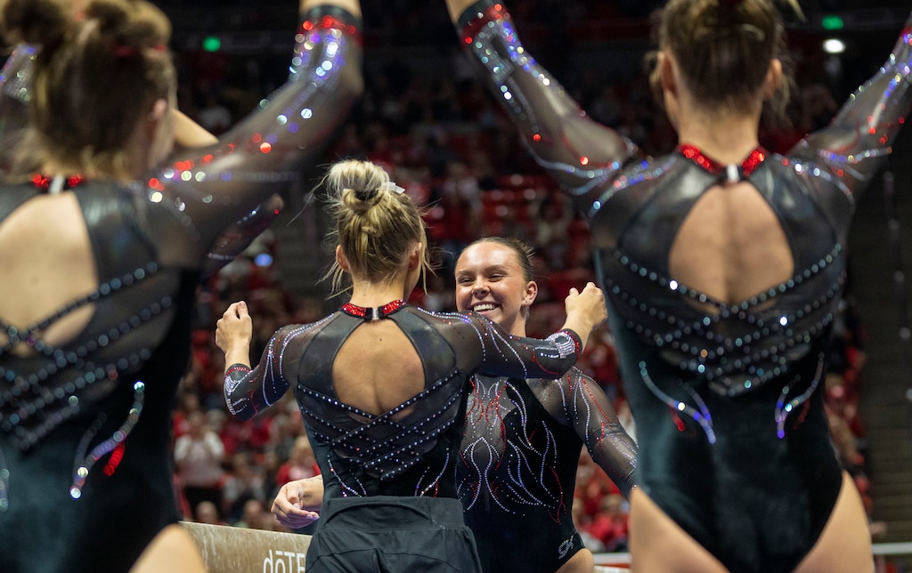 (Rick Egan | The Salt Lake Tribune)  Maile O'Keefe gets hug form a team mate after scoring a 10 on the beam, in gymnastics action between Utah  Red Rocks and Oregon State, at the Jon M. Huntsman Center, on Friday, Feb. 2, 2024.
