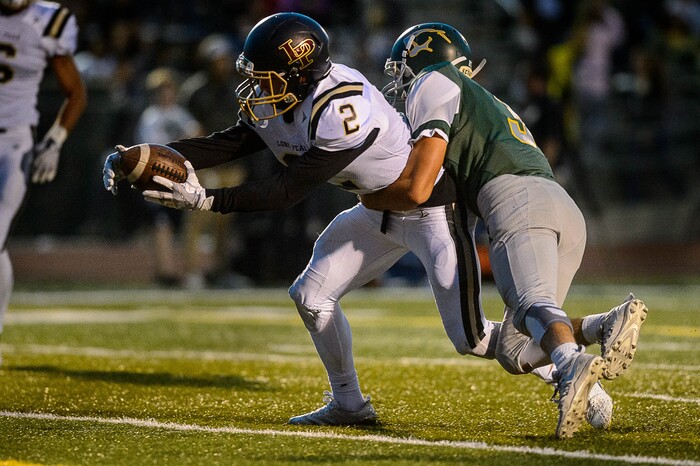 (Trent Nelson | The Salt Lake Tribune) Lone Peak's Brigham Trowbridge punches the ball over the goal line as Kearns hosts Lone Peak, high school football, Thursday September 14, 2017.