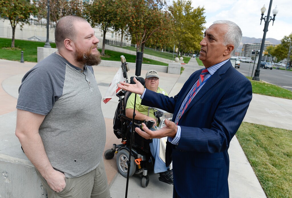 (Francisco Kjolseth | The Salt Lake Tribune) Jacob Jensen, left, and Adam Guymon, both organizers of Utah Against Police Brutality (UAPB), speak with District Attorney Sim Gill outside his office on Monday, Oct. 1, 2018, as they bring attention and reject his decision to not file charges against a West Valley officer who shot and killed Elijah Smith.