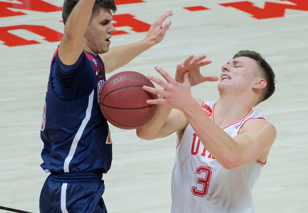 (Leah Hogsten | The Salt Lake Tribune) Utah Utes guard Pelle Larsson (3) draws the foul on Arizona Wildcats guard Kerr Kriisa (25) as the University of Utah host the Arizona Wildcats, Feb. 4, 2021 at the Jon M. Huntsman Arena.