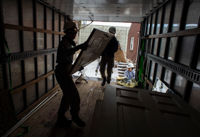 (Rick Egan  |  The Salt Lake Tribune)       Tierra Pouttu-Clarke and Taylor Drake from AmeriCorps, removes a closet door from a home that will be demolished for freeway widening, for UDOT and Habitat for Humanity, Wednesday, Jan. 16, 2019.





