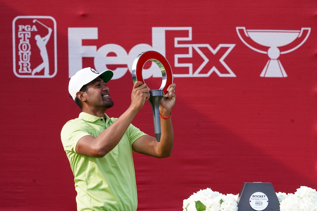 Tony Finau holds the winner's trophy after the final round of the Rocket Mortgage Classic golf tournament, Sunday, July 31, 2022, in Detroit. (AP Photo/Carlos Osorio)