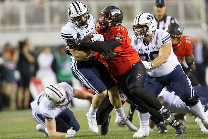 UNLV defensive lineman Nick Dehdashtian (98) tackles BYU running back Austin Kafentzis (2) during an NCAA college football game Friday, Nov. 10, 2017, in Las Vegas. (Erik Verduzco/Las Vegas Review-Journal via AP)