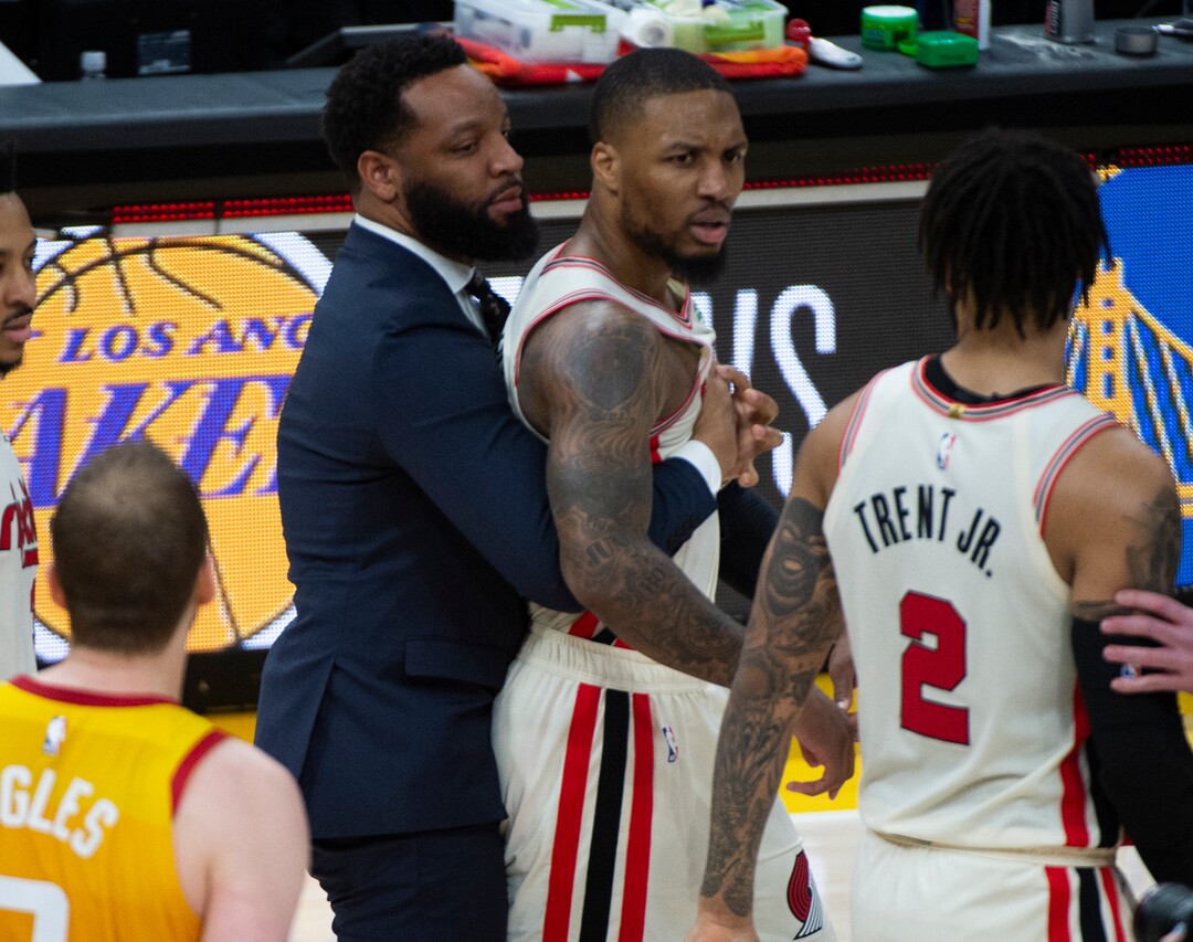 (Rick Egan  |  The Salt Lake Tribune)     Trail Blazers guard Damian Lillard (0) his restrained by a member of the Portland coaching staff, as the buzzer sounds, in the Jazz 117-114 win over the Portland Trail Blazers, in NBA action in Salt Lake City, Friday, Feb. 7, 2020.