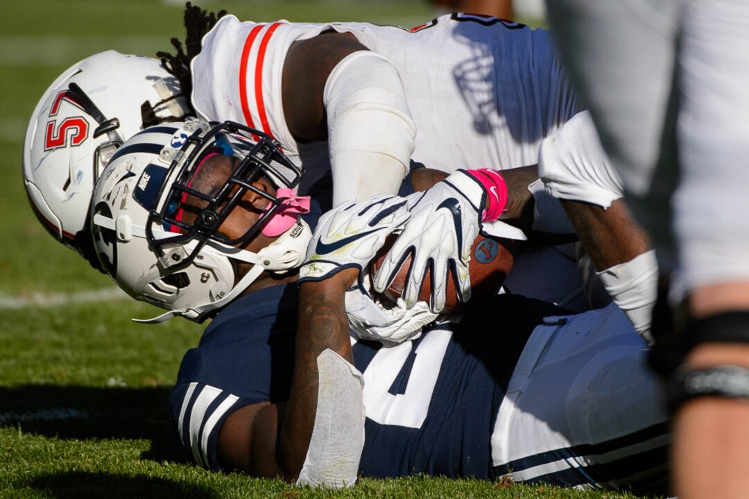 (Trent Nelson | The Salt Lake Tribune)  Northern Illinois Huskies linebacker Kyle Pugh (57) brings down Brigham Young Cougars running back Squally Canada (22) as BYU hosts Northern Illinois, NCAA football in Provo, Saturday Oct. 27, 2018.
