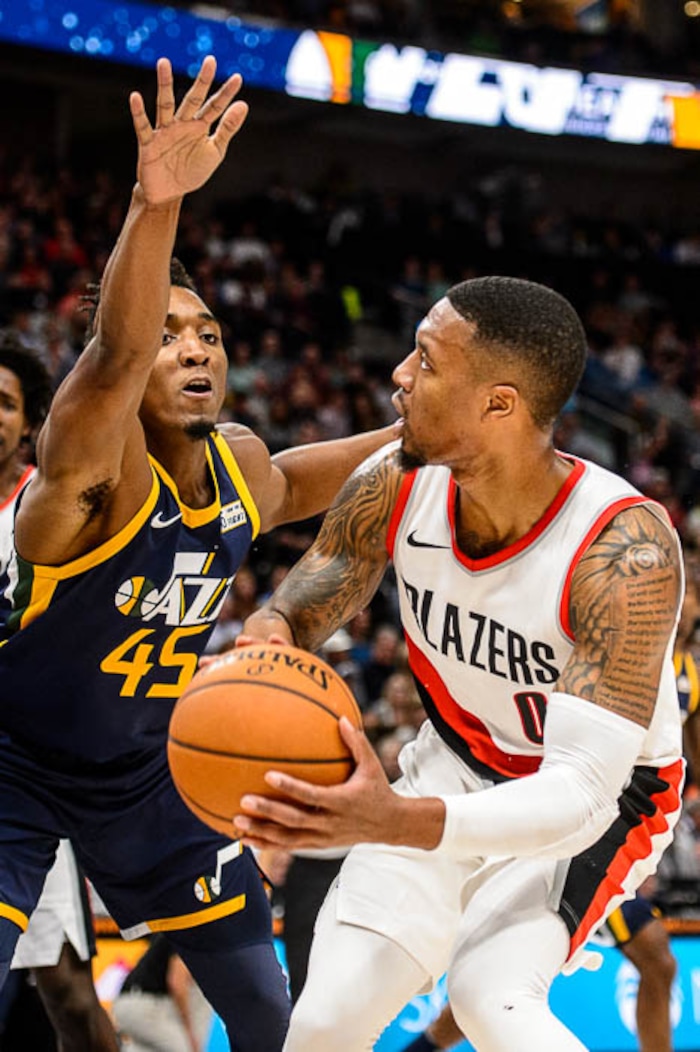 (Trent Nelson | The Salt Lake Tribune)  Utah Jazz guard Donovan Mitchell (45) defending Portland Trail Blazers guard Damian Lillard (0) as the Utah Jazz host the Portland Trail Blazers, NBA basketball in Salt Lake City, Wednesday November 1, 2017.